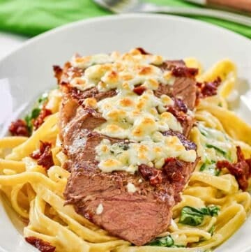Copycat Olive Garden steak gorgonzola alfredo on a platter.