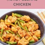 A bowl of copycat Panera honey sesame chicken on a marble surface.