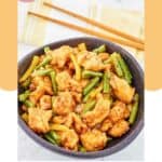 Homemade Panda Express honey sesame chicken in a bowl and chopsticks behind it.