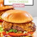 Homemade Chili's old timer burger with cheese on a wood board.