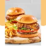 Two homemade Chili's oldtimer burgers and fries on a wood board.