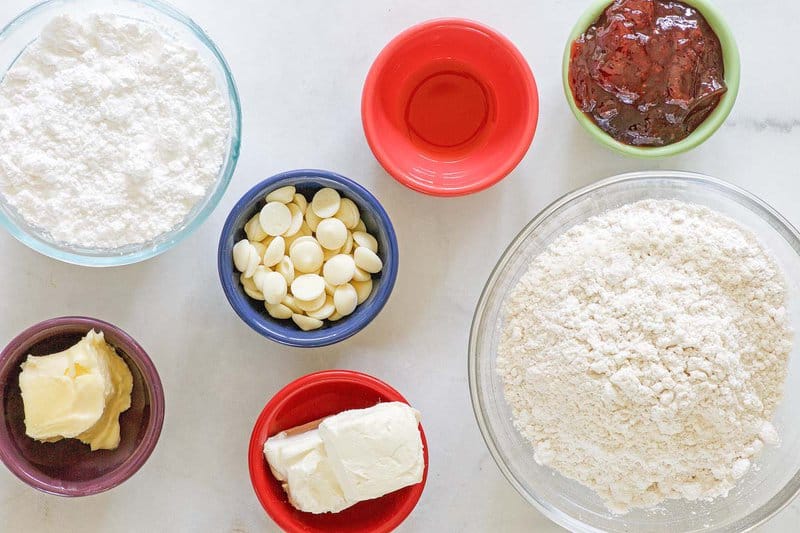 Copycat Denny's strawberry pancake puppies and cheesecake dip ingredients in bowls.