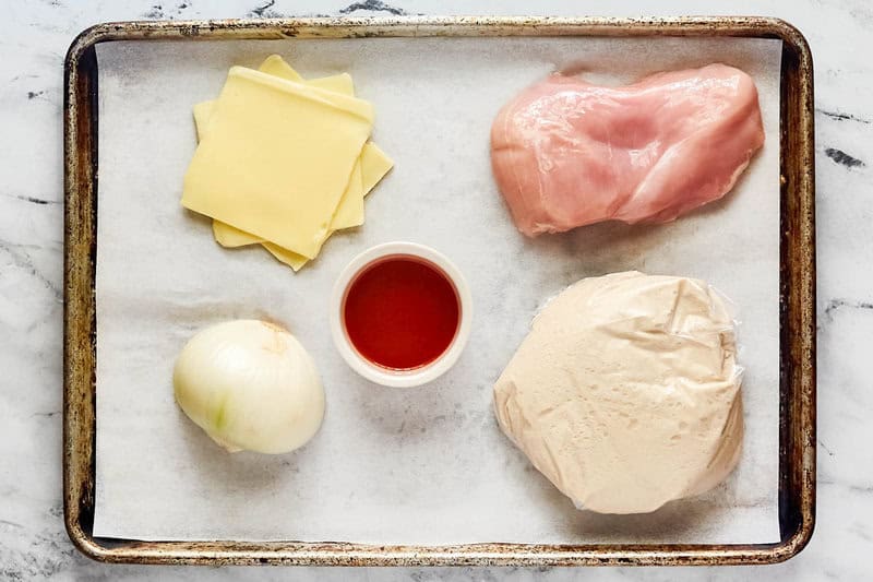 Copycat Domino's buffalo chicken pizza ingredients on a tray.