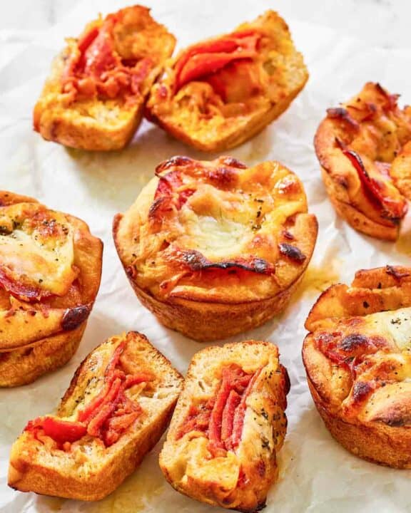 Copycat Little Caesars crazy puffs with pepperoni on parchment paper.