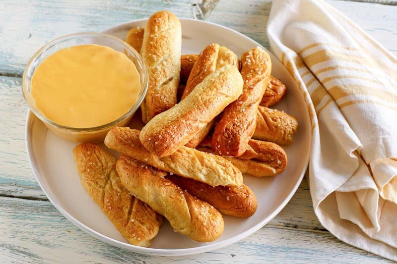 Copycat TGI Friday's preztel sticks and beer cheese dip next to them.