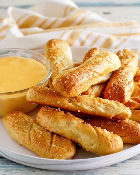 Copycat TGI Friday's soft pretzel sticks and beer cheese dip on a plate.