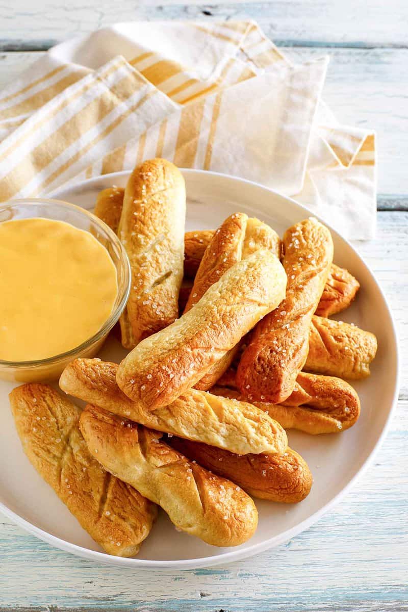 Copycat TGI Friday's pretzel sticks and beer cheese dipping sauce on a plate.