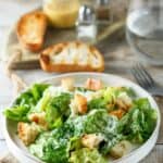 Homemade Anthony's Caesar salad and toasted bread slices.