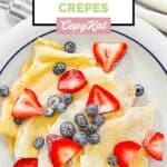 Homemade IHOP crepes with blueberries and strawberries on top.