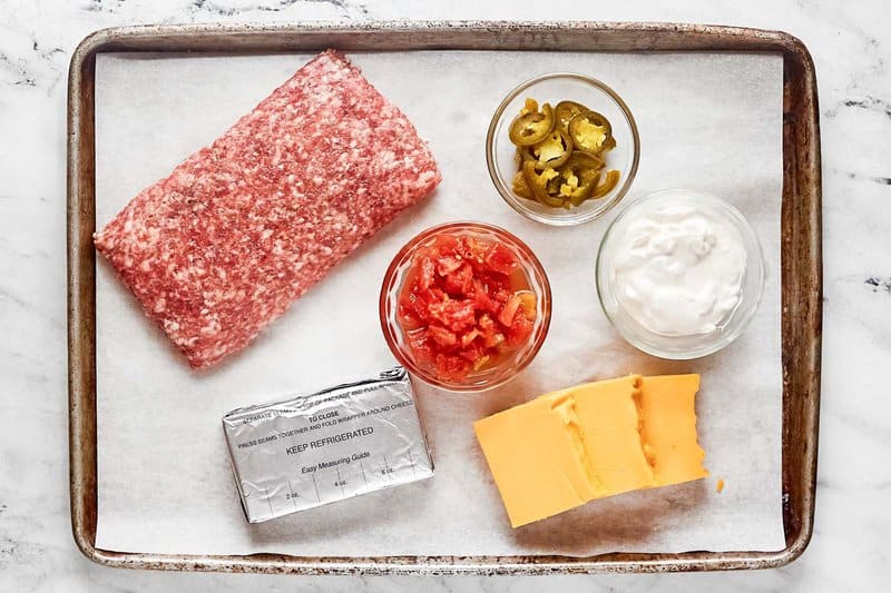 Rotel sausage cream cheese dip ingredients on a tray.