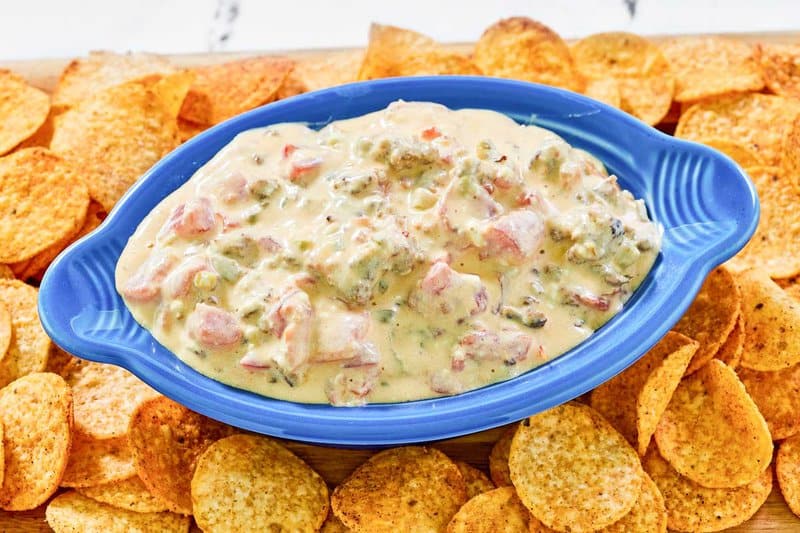 Rotel sausage cream cheese dip and tortilla chips on a platter.