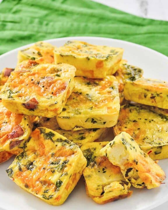 Copycat Starbucks potato cheddar and chive bakes piled on a platter.