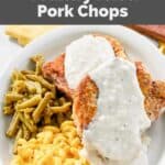 Two homemade Cracker Barrel country fried pork chops with gravy on a plate.