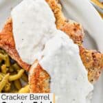 Homemade Cracker Barrel country fried pork chops topped with gravy.