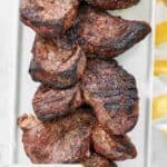 Several grilled picanha steaks on a platter.