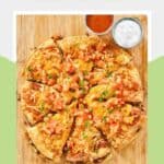 A sliced copycat Taco Bell Mexican pizza on a pizza peel.