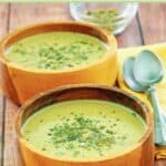 Acorn squash soup and spoons on a cloth napkin.