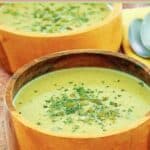 A bowl of acorn squash soup topped with seeds.