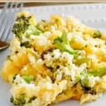 A serving of broccoli rice casserole with cheese on a plate.