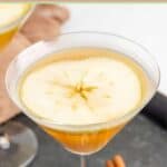Caramel apple martini with an apple slice garnish.