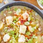 A bowl of cheeseburger soup with hamburger bun croutons.
