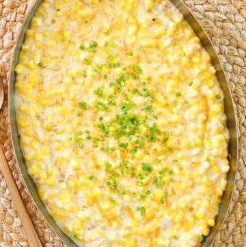 Cheesy creamed corn in a large copper skillet.