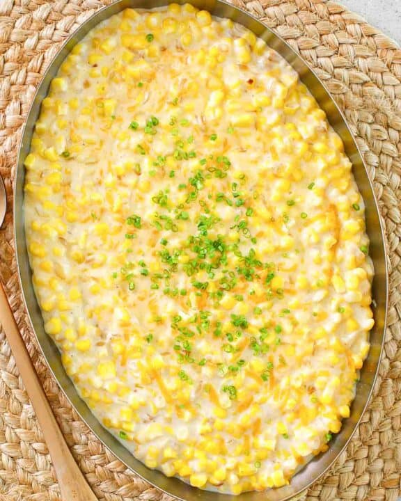 Cheesy creamed corn in a large copper skillet.