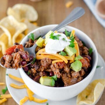 Chili on a spoon on top of a bowl of chili.
