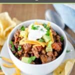 Chili topped with cheese, sour cream, and avocado.