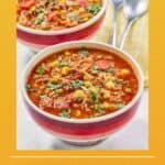Cowboy soup in two bowls and two spoons on napkins.