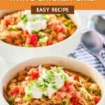 Bowls of crockpot white chicken chili topped with sour cream.