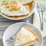 Homemade double layer pumpkin pie and forks next to it.