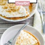 Double layer pumpkin pie slice on a plate next to the pie.