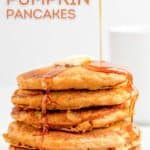 Pouring syrup over a stack of copycat IHOP pumpkin pancakes.