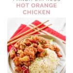 Copycat Panda Express hot orange chicken and steamed white rice on a plate.