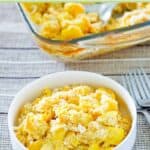 Squash casserole made with ritz crackers in a bowl in front of the casserole dish.