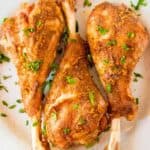 Roasted turkey legs garnished with fresh parsley.