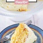 Old fashioned ambrosia cake and a fork on a plate.