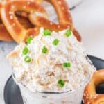Cold beer cheese dip and soft pretzels behind it.