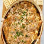 Boudin sausage dip with cheese in a serving dish.