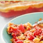 Cherry pineapple dump cake in a small bowl and a baking dish.