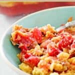 A serving of cherry pineapple dump cake in a small bowl.