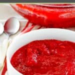 Homemade cranberry jello salad and spoons on a table.