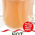 Homemade hot buttered rum cocktail in a glass mug.