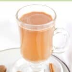 Homemade hot buttered rum in a mug on a coaster.