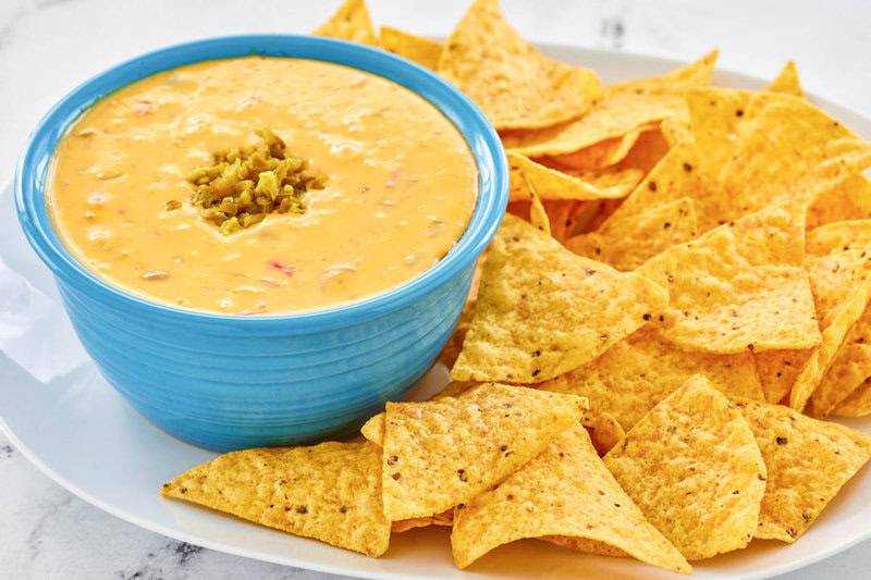 Copycat Pappasito's queso dip with tortilla chips.