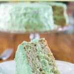 Pistachio cake and a slice on a plate.