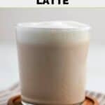 Homemade Starbucks London fog tea latte on a coaster on top of a cloth napkin.