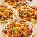Copycat taco villa mexican pizza things on a wood serving board.