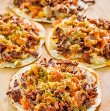 Copycat taco villa mexican pizza things on a wood serving board.